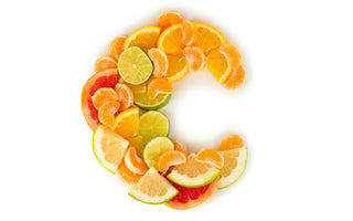 Oranges, grapefruits and other citrus fruits sliced in the shape of the letter C for Vitamin C